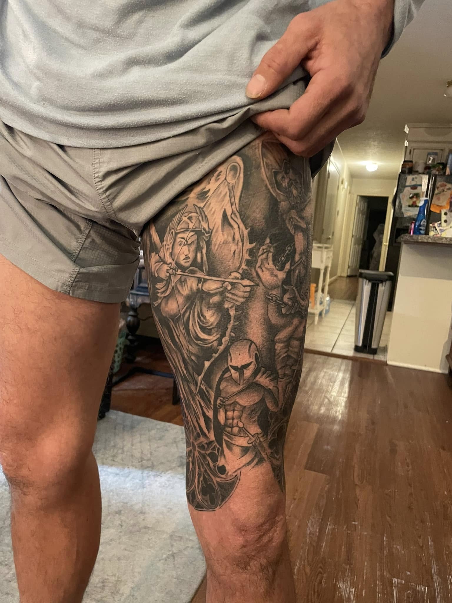 Detailed black and grey leg tattoo