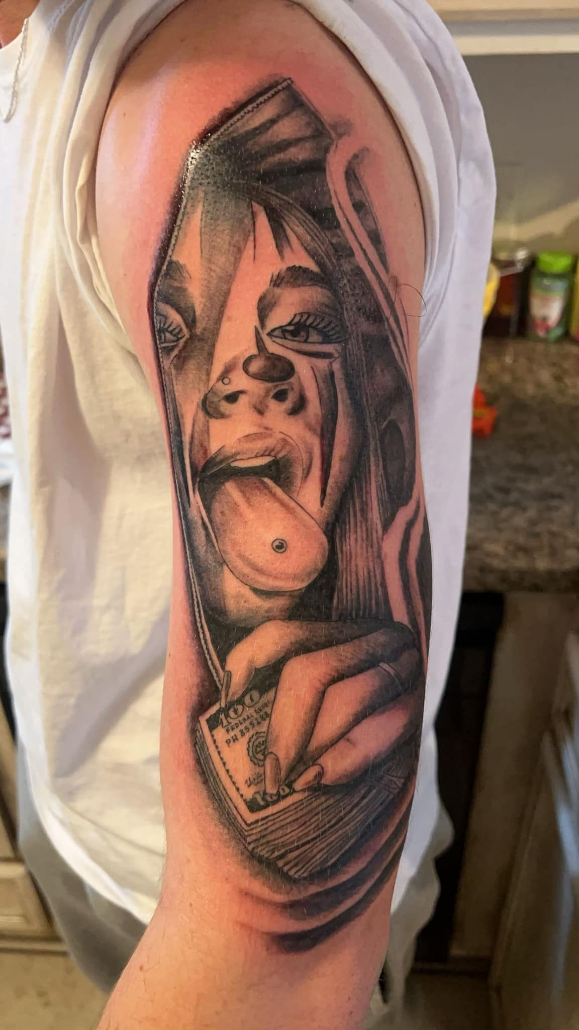 Stylized face with tongue piercing and money arm tattoo