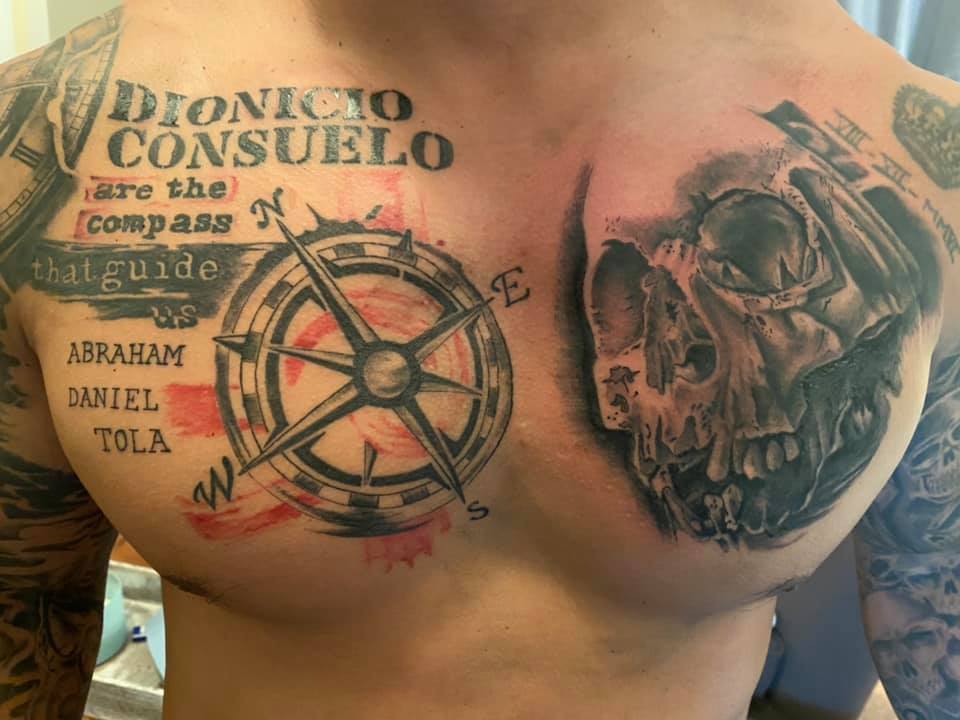 Compass and skull chest tattoo with text