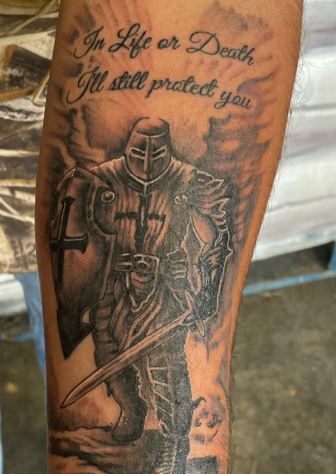 Forearm tattoo of a knight in armor with text 'In Life or Death I'll still protect you'