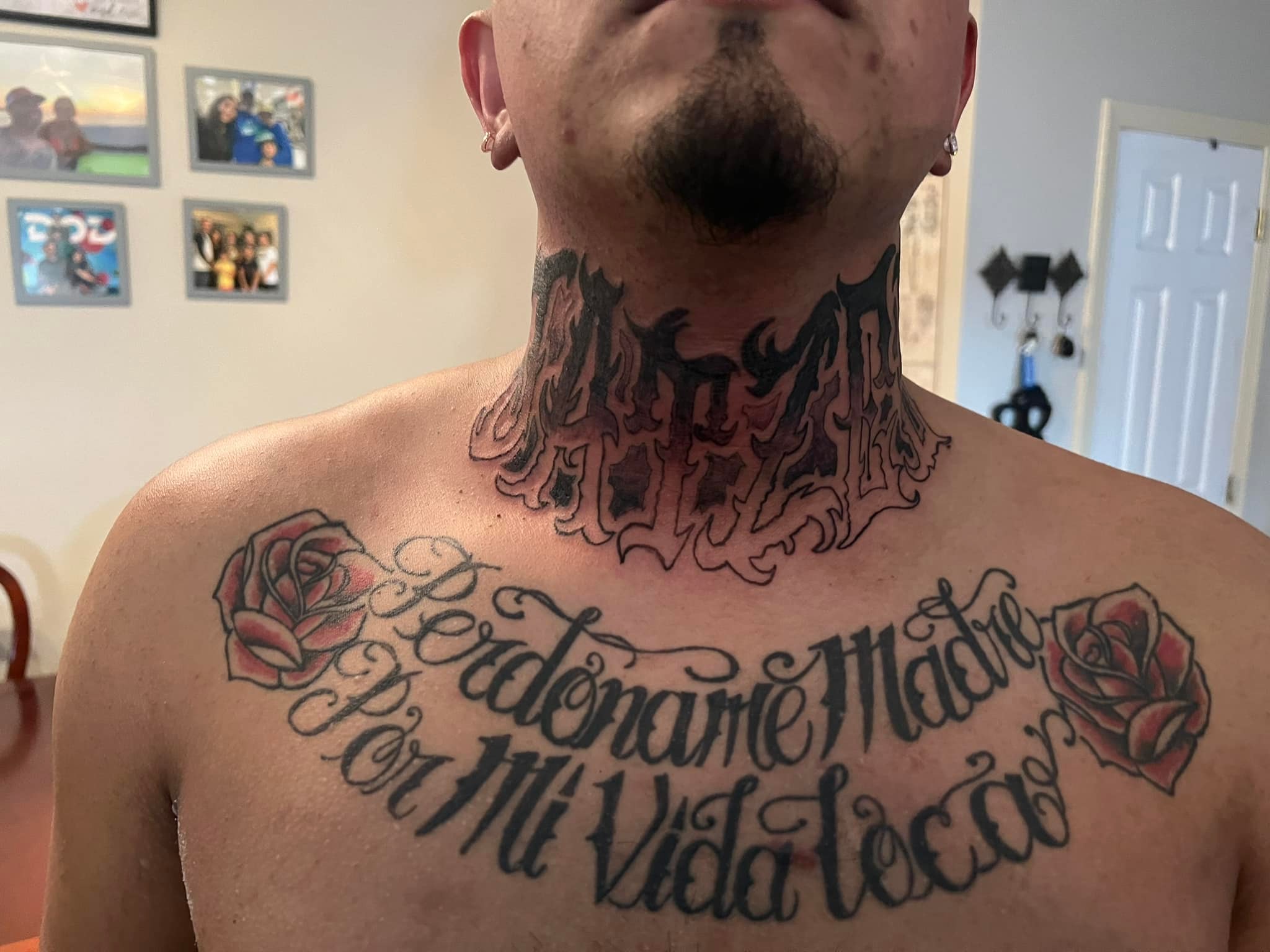 Lettering and roses chest tattoo